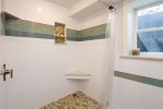 Lower level renovated full bath with shower and twin sinks